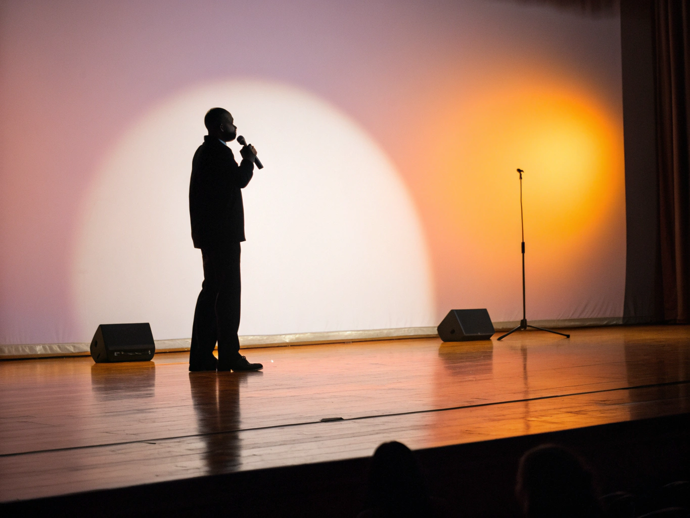 Speaker presenting on a stage with warmth
